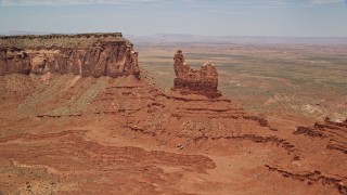 AX136_043E - 5.5K aerial stock footage of approaching and flying over Setting Hen Butte, Monument Valley, Utah, Arizona