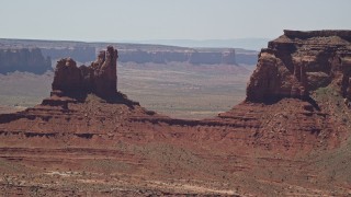 AX136_045 - 5.5K aerial stock footage of flying away from Setting Hen Butte in Monument Valley, Utah, Arizona