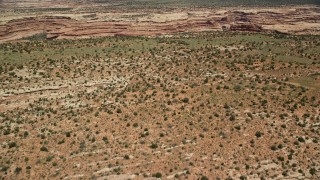 AX136_064E - 5.5K aerial stock footage fly over mesa to approach a canyon, Cedar Mesa, Utah