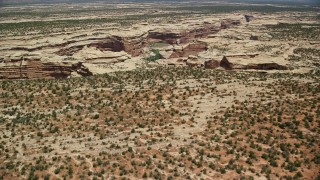AX136_082E - 5.5K aerial stock footage of approaching Grand Gulch and pan across the deep canyon, Grand Gulch Primitive Area, Utah