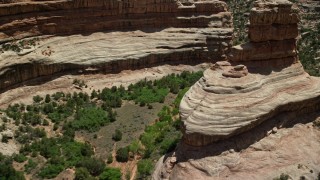 AX136_101E - 5.5K aerial stock footage of flying low altitude through Grand Gulch, Grand Gulch Primitive Area, Utah