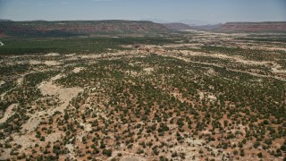 AX136_111E - 5.5K aerial stock footage of flying over and panning across shallow canyons, Natural Bridges National Monument, Utah