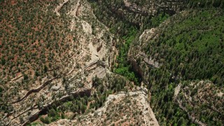 AX136_168 - 5.5K aerial stock footage of tilt from bird's eye view of Arch Canyon, Utah, then fly away