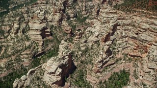 AX136_172 - 5.5K aerial stock footage of orbiting a canyon with rock formations, Manti-La Sal National Forest, Utah