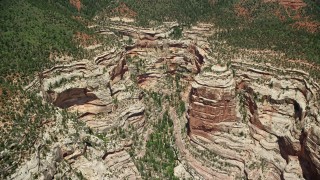 AX136_173 - 5.5K aerial stock footage of flying by a box canyon in Manti-La Sal National Forest, Utah