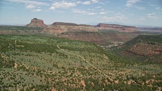 AX136_193E - 5.5K aerial stock footage of approaching Cathedral Butte and mesas, Manti-La Sal National Forest, Utah