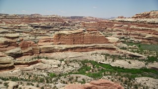 AX136_208E - 5.5K aerial stock footage of flying over and approaching rock formations, Canyonlands National Park, Utah