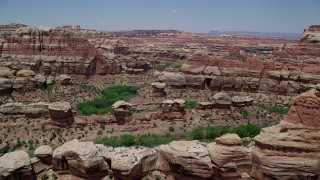 AX136_210 - 5.5K aerial stock footage of flying over rock formations and canyons, Canyonlands National Park, Utah