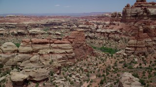 AX136_211 - 5.5K aerial stock footage of flying over rock formations, boulders and canyons, Canyonlands National Park, Utah