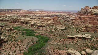 AX136_211E - 5.5K aerial stock footage of flying over boulders, rock formations and canyons, Canyonlands National Park, Utah