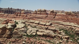 AX136_213 - 5.5K aerial stock footage of flying by canyons between rock formations, Canyonlands National Park, Utah