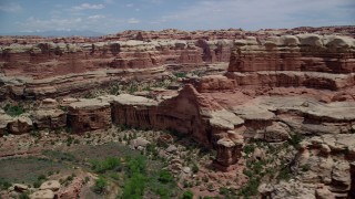 AX136_214 - 5.5K aerial stock footage of passing by canyons between rock formations, Canyonlands National Park, Utah