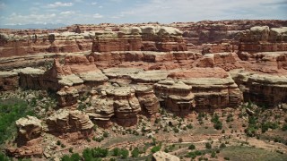 AX136_214E - 5.5K aerial stock footage tilt and fly over rock formations and desert canyons, Canyonlands National Park, Utah