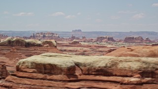 AX136_219E - 5.5K aerial stock footage of flying by rock formations in Canyonlands National Park, Utah