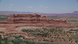 AX136_225 - 5.5K aerial stock footage of passing by Squaw Butte at Canyonlands National Park, Utah