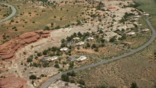AX136_226 - 5.5K aerial stock footage of orbiting rural homes by Residence Road, Canyonlands National Park, Utah
