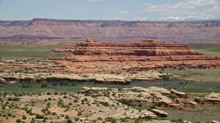 AX136_227E - 5.5K aerial stock footage of desert butte in Canyonlands National Park, Utah