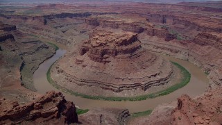 AX136_235 - 5.5K stock footage aerial video orbit and fly away from Colorado River through Meander Canyon, Canyonlands National Park, Utah
