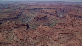 AX136_236 - 5.5K aerial stock footage of flying by Colorado River through Meander Canyon, Canyonlands National Park, Utah