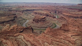 AX136_238E - 5.5K aerial stock footage of flying toward the Colorado River and butte in Meander Canyon, Canyonlands National Park, Utah