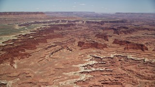 AX136_246E - 5.5K aerial stock footage approach buttes and canyons near White Rim cliffs, Canyonlands National Park, Utah