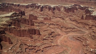 AX136_252E - 5.5K aerial stock footage of flying away from steep buttes, Monument Canyon, and White Rim, Canyonlands National Park, Utah
