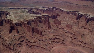 AX136_253 - 5.5K aerial stock footage of flying away from steep buttes, Monument Canyon, and White Rim, Canyonlands National Park, Utah