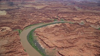 AX136_257 - 5.5K aerial stock footage of flying over Colorado River, approaching canyons, Canyonlands National Park, Utah