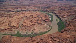 AX136_258 - 5.5K aerial stock footage of flying by Colorado River through Meander Canyon, Canyonlands National Park, Utah