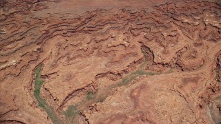 AX136_259E - 5.5K aerial stock footage tilt from buttes, reveal Colorado River and Meander Canyon, Canyonlands National Park, Utah