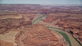 AX136_261E - 5.5K aerial stock footage of flying toward the Colorado River in Meander Canyon, Canyonlands National Park, Utah
