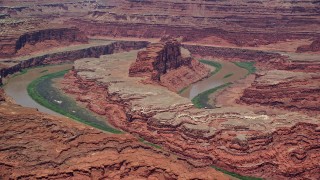 AX136_264E - 5.5K aerial stock footage of the Colorado River and a butte in Goose Neck part of Meander Canyon, Canyonlands National Park, Utah