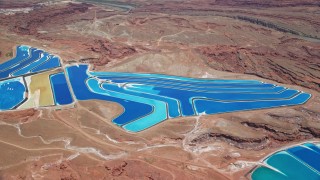 AX136_271E - 5.5K aerial stock footage of bird's eye view of potash ponds in a desert valley, Moab, Utah