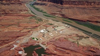 AX136_276E - 5.5K aerial stock footage of a bird's eye view of the Intrepid Potash plant by the Colorado River, Moab, Utah