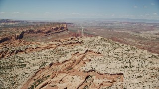 AX136_283E - 5.5K aerial stock footage of Highway 191 through a desert valley, Moab, Utah
