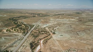 AX136_293E - 5.5K aerial stock footage of approaching Highway 191 in a desert valley, Moab, Utah