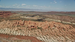 AX137_004E - 5.5K aerial stock footage of flying by desert rock formations at Arches National Park, Utah