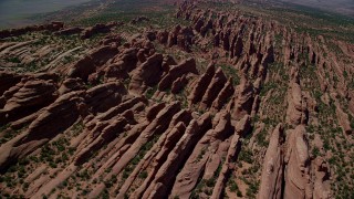 AX137_014 - 5.5K aerial stock footage of passing by rock fins in Devil's Garden, Arches National Park, Utah