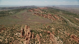 AX137_022E - 5.5K aerial stock footage fly over rock fins and and desert plants in Eagle Park, Arches National Park, Utah