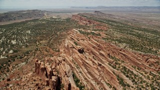 AX137_026E - 5.5K aerial stock footage of passing over rock fins and vegetation in Eagle Park, Arches National Park, Utah