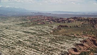 AX137_052E - 5.5K aerial stock footage of passing rock formations and desert plants in Devil's Garden, Arches National Park, Utah