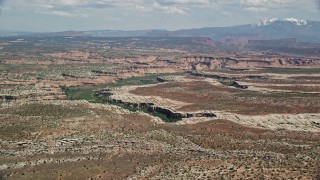 AX137_054E - 5.5K aerial stock footage of approaching Salt Wash Canyons at Arches National Park, Utah