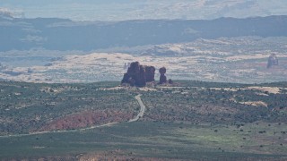 AX137_059E - 5.5K aerial stock footage of a view of Balanced Rock and Scenic Drive, Arches National Park, Utah