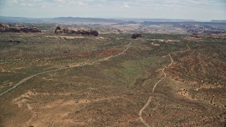 AX137_063E - 5.5K aerial stock footage of flying by Ham Rock and Balanced Rock near Arches Scenic Drive, Arches National Park, Utah