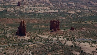 AX137_065 - 5.5K stock footage aerial video of passing near Balanced Rock and Arches Scenic Drive, Arches National Park, Utah