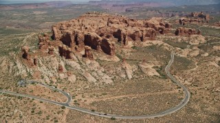 AX137_070E - 5.5K aerial stock footage fly over and tilt to Elephant Butte and Double Arch, Arches National Park, Utah