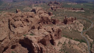 AX137_071 - 5.5K stock footage aerial video fly over and tilt to Elephant Butte and Double Arch, Arches National Park, Utah