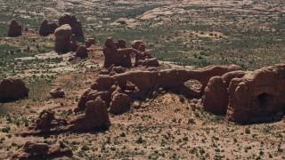 AX137_075 - 5.5K aerial stock footage of North Window, South Window, Turret Arch rock formations, Arches National Park, Utah