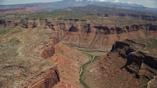 AX137_076E - 5.5K aerial stock footage of the Colorado River and a canyon road, Arches National Park, Utah