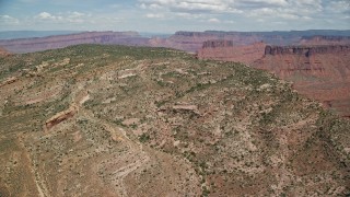 AX137_081 - 5.5K aerial stock footage fly over the top of Dry Mesa in Moab, Utah
